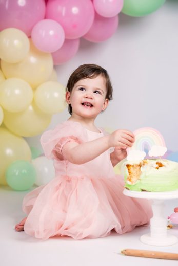 Twin girl Rainbow cake smash theme laughing with cake