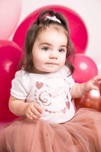 Baby playing with balloons