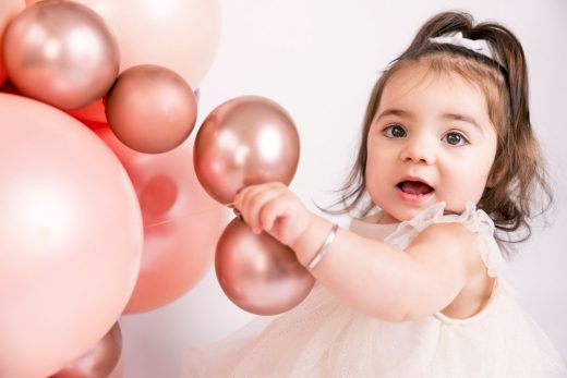 Baby playing with balloons